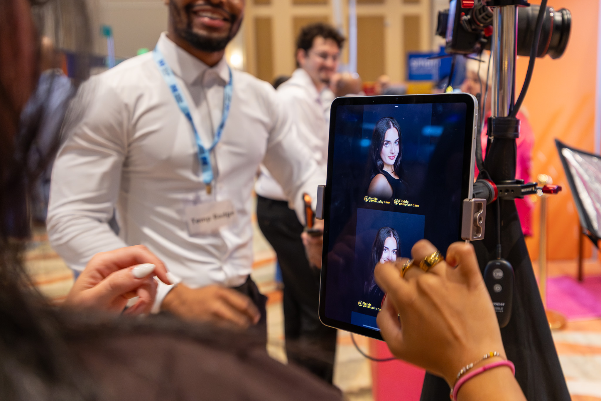 Woman looking at her headshot photos on the sharing station